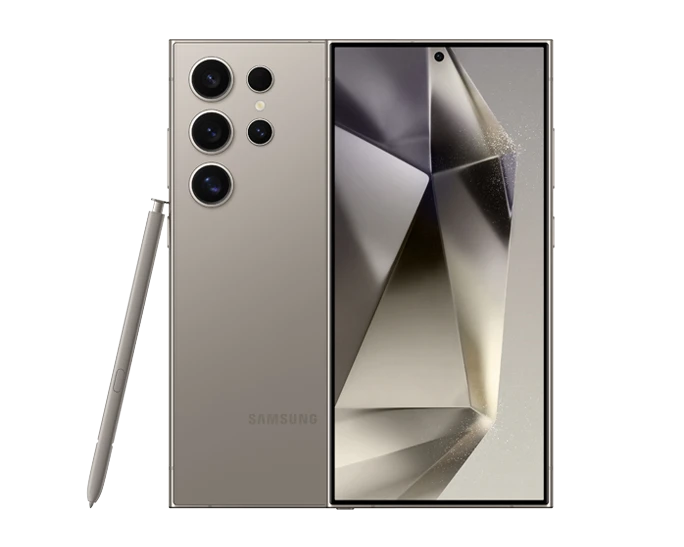 A photorealistic rendering of the Samsung Galaxy S24 Ultra smartphone in a sleek, titanium gray finish. The phone is shown resting on a flat surface, with the S Pen stylus positioned next to it. The image highlights the phone's slim profile, edge-to-edge display, and quad-lens rear camera system.
