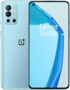A photorealistic image of a OnePlus 9R smartphone in a gradient blue finish. The phone is displayed against a black background and features the text "48M OIS 14-26MM" etched near the camera module. The OnePlus logo is visible on the lower back of the phone.