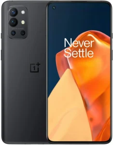 A photorealistic image of a OnePlus 9R smartphone in a gradient blue finish. The phone is displayed against a black background and features the text "48M OIS 14-26MM" etched near the camera module. The OnePlus logo is visible on the lower back of the phone.
